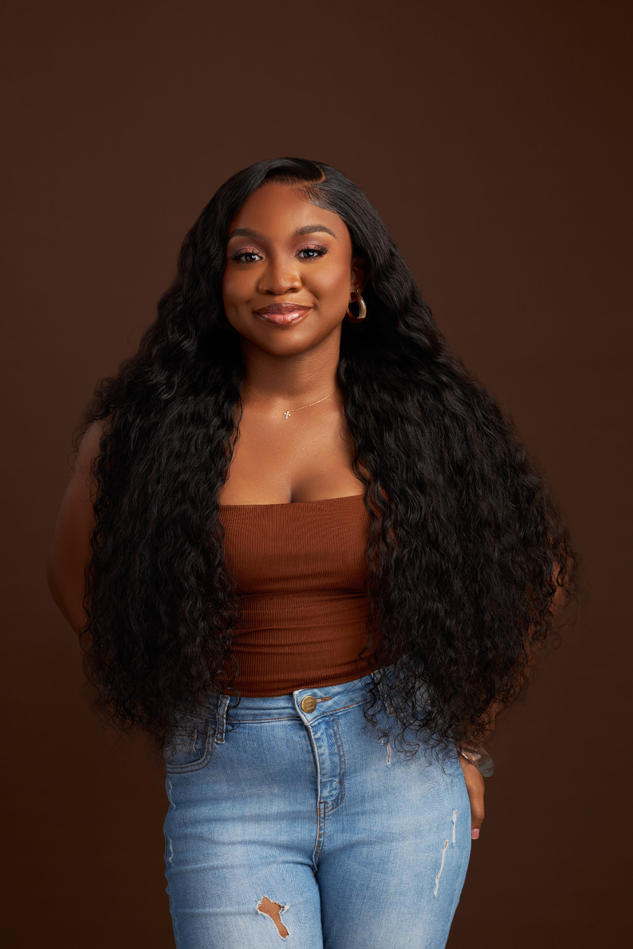 Model wearing a long deep wave wig
